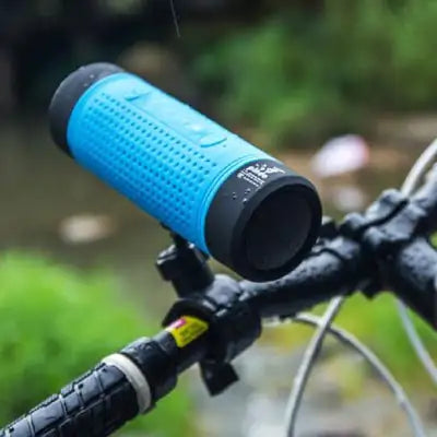 Waterproof bike speaker with Bluetooth and LED light mounted on bike handlebars.