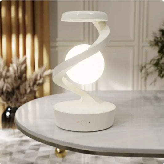 Rotating Moon Desk Lamp with wireless charging and touch sensor on a table.